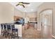 Open kitchen with wood cabinetry, granite countertops, and a breakfast bar with seating at 10495 Atenia St, Port Charlotte, FL 33981