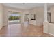 Spacious living room featuring neutral walls, tile flooring, and sliding glass doors to the outdoor area at 10495 Atenia St, Port Charlotte, FL 33981