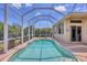 Sparkling blue pool inside a screened enclosure, offering a private outdoor retreat at 10495 Atenia St, Port Charlotte, FL 33981