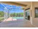 Screened-in pool with clear blue water, surrounded by lush landscaping at 10495 Atenia St, Port Charlotte, FL 33981