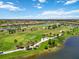 Expansive aerial view of a golf course community with lakes, residential areas, and beautifully landscaped grounds at 10805 Tarflower Dr # 101, Venice, FL 34293