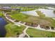 Beautiful aerial view of a golf course featuring manicured greens, sand traps, and scenic waterways at 10805 Tarflower Dr # 101, Venice, FL 34293