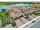 Beautiful aerial shot showcasing the home's tile roofs, private driveways, and scenic lake views at 10805 Tarflower Dr # 101, Venice, FL 34293