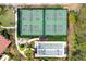 Aerial view of tennis and bocce ball courts with lush landscaping at 10805 Tarflower Dr # 101, Venice, FL 34293