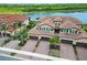 Fantastic aerial perspective shows the tile roofs, lake views, and lush landscaping of this community at 10805 Tarflower Dr # 101, Venice, FL 34293