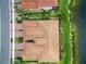 Birds eye view showcases a villa's tile roof with lush green grass that extends to a large lake at 10805 Tarflower Dr # 101, Venice, FL 34293