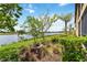 Picturesque backyard featuring a serene lake view, lush greenery, and a well-maintained lawn at 10805 Tarflower Dr # 101, Venice, FL 34293