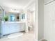Bright bathroom featuring tile flooring, double sinks, a framed mirror, and a walk-in shower at 10805 Tarflower Dr # 101, Venice, FL 34293