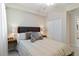 This cozy bedroom features neutral tones, a ceiling fan, and a spacious closet at 10805 Tarflower Dr # 101, Venice, FL 34293