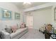 Bright bedroom features art on the walls, a sofa, and a chair with ottoman at 10805 Tarflower Dr # 101, Venice, FL 34293