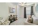 Bright bedroom featuring neutral paint, a console table, and a comfortable sofa at 10805 Tarflower Dr # 101, Venice, FL 34293