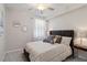 Bedroom with a queen bed, ceiling fan, bedside tables, and decorative wall mirrors at 10805 Tarflower Dr # 101, Venice, FL 34293