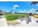 Convenient bike rack area near a community amenity, surrounded by lush greenery and a secure fence at 10805 Tarflower Dr # 101, Venice, FL 34293