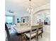 Bright dining area with modern table, chairs, and stylish chandelier, perfect for entertaining or Gathering meals at 10805 Tarflower Dr # 101, Venice, FL 34293