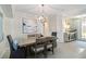 Dining area featuring a modern light fixture, neutral wall color, and dining table with seating for six at 10805 Tarflower Dr # 101, Venice, FL 34293