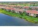 Beautiful waterfront condos with lush green lawns and terra cotta tile roofs in a sunny, landscaped community at 10805 Tarflower Dr # 101, Venice, FL 34293