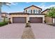 Charming two-story home featuring a red-brick driveway and symmetrical facades with attached garages at 10805 Tarflower Dr # 101, Venice, FL 34293