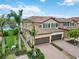 Beautiful home features a tile roof, two-car garage and is enhanced by verdant landscaping and brick paver driveway at 10805 Tarflower Dr # 101, Venice, FL 34293