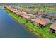 Beautiful waterfront condos with lush green lawns and terra cotta tile roofs in a sunny, landscaped community at 10805 Tarflower Dr # 101, Venice, FL 34293