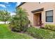 Charming front entrance with lush landscaping and a welcoming walkway, creating a great curb appeal at 10805 Tarflower Dr # 101, Venice, FL 34293