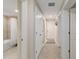 Hallway leading to bathroom and linen closet with tile floors at 10805 Tarflower Dr # 101, Venice, FL 34293
