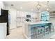Open kitchen featuring a spacious island with seating and modern appliances at 10805 Tarflower Dr # 101, Venice, FL 34293