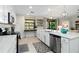 Bright kitchen features white cabinets, stainless steel appliances, and tile backsplash, offering modern style and functionality at 10805 Tarflower Dr # 101, Venice, FL 34293