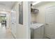 Laundry room with a new washer and dryer, a wire basket, and a door at 10805 Tarflower Dr # 101, Venice, FL 34293