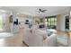 Bright living room with large windows and modern kitchen view, perfect for entertaining at 10805 Tarflower Dr # 101, Venice, FL 34293