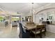 Bright living and dining area with large windows, a modern chandelier, and tile flooring throughout at 10805 Tarflower Dr # 101, Venice, FL 34293