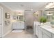 Bright bathroom with a glass shower and and sinks with vanity mirrors at 10805 Tarflower Dr # 101, Venice, FL 34293
