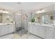 Bathroom featuring a glass shower, and sinks, and neutral tile at 10805 Tarflower Dr # 101, Venice, FL 34293