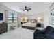 Bright main bedroom with a ceiling fan, bench, and a view of the lake at 10805 Tarflower Dr # 101, Venice, FL 34293