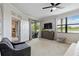 Bright main bedroom featuring a ceiling fan, walk-out patio, and great natural light at 10805 Tarflower Dr # 101, Venice, FL 34293