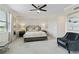 Bright main bedroom with a ceiling fan and elegant decor at 10805 Tarflower Dr # 101, Venice, FL 34293