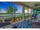 Screened lanai provides a relaxing space with serene lake views, furnished with comfortable seating and stylish decor at 10805 Tarflower Dr # 101, Venice, FL 34293