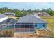 Back of the house with a screened lanai and a pool at 12359 Deepwoods Ave, Port Charlotte, FL 33981