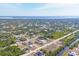 Stunning aerial view of homes nestled in a lush, green landscape near a tranquil body of water at 12359 Deepwoods Ave, Port Charlotte, FL 33981