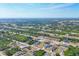 Expansive aerial shot of a residential neighborhood, showcasing the community's layout and green surroundings at 12359 Deepwoods Ave, Port Charlotte, FL 33981