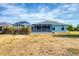 View of the screened lanai with pool in the backyard with lawn at 12359 Deepwoods Ave, Port Charlotte, FL 33981