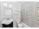 Bathroom featuring a modern sink and vanity, toilet, and tub with stylish shower curtain at 12359 Deepwoods Ave, Port Charlotte, FL 33981
