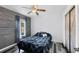Bedroom boasts wood-look flooring and accent wall, complemented by a modern ceiling fan for added comfort at 12359 Deepwoods Ave, Port Charlotte, FL 33981