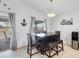 Dining area with table and seating for four, a water cooler and decorative anchor at 12359 Deepwoods Ave, Port Charlotte, FL 33981