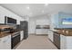 Spacious kitchen with stainless steel appliances, white cabinetry, and granite countertops at 12359 Deepwoods Ave, Port Charlotte, FL 33981