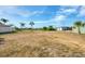 Vacant grassy lot with power lines and foliage at 12359 Deepwoods Ave, Port Charlotte, FL 33981
