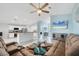 Bright living room showcasing tile floors, an open layout, an eat-in kitchen and comfortable furnishings at 12359 Deepwoods Ave, Port Charlotte, FL 33981
