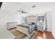 Bright main bedroom with hardwood floors, ceiling fan, and a king-size bed at 12359 Deepwoods Ave, Port Charlotte, FL 33981