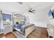 Spacious main bedroom with a king-size bed, hardwood floors, and white walls at 12359 Deepwoods Ave, Port Charlotte, FL 33981