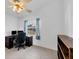 Bright office space featuring a ceiling fan, large window, desk and comfortable chair at 12359 Deepwoods Ave, Port Charlotte, FL 33981