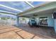 Relaxing pool-side patio featuring a dining set with comfortable seating and a view of the pool and backyard at 12359 Deepwoods Ave, Port Charlotte, FL 33981